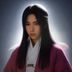 内容分析师王博的工作照，手持平板电脑查阅资料，背景为明亮的办公环境